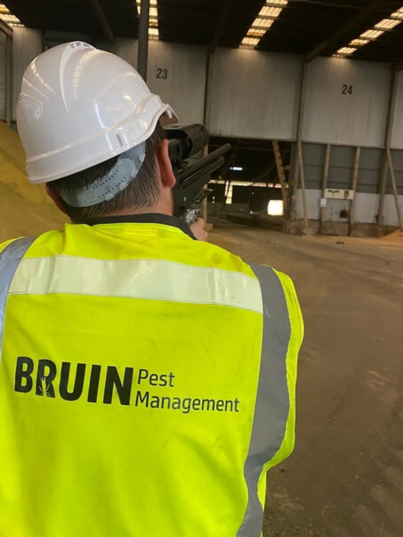 Bruin technician in hi-vis inspecting a Brisbane warehouse for pests